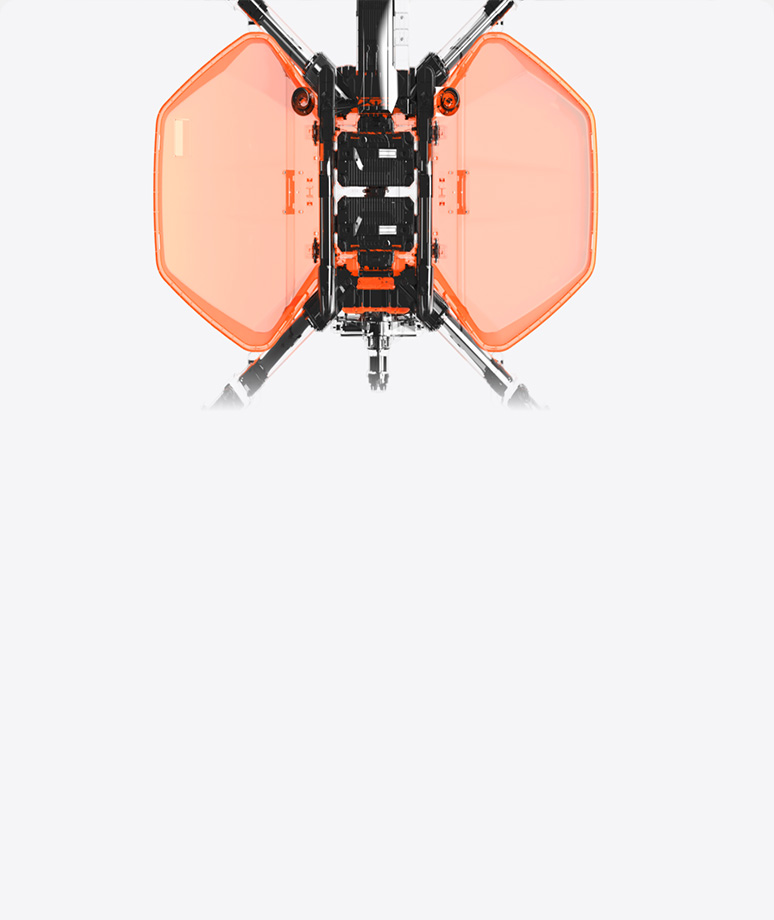Top-down view of a mechanical device with two large, translucent orange panels and black central components against a white background.